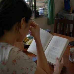 Một người phụ nữ trẻ đang chau mày nhìn vào màn hình máy tính, thể hiện sự khó khăn trong việc tìm kiếm thông tin mắt kính đáng tin cậy.